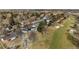 Overhead shot of a neighborhood bordering a golf course, with houses nestled among mature trees and green spaces at 22 Wedge Way, Littleton, CO 80123