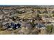 Birds-eye view of a tranquil neighborhood featuring lush greenery, a golf course, and well-maintained homes at 22 Wedge Way, Littleton, CO 80123