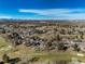 Expansive aerial shot showcases the neighborhood's mature landscaping, golf course, and scenic surroundings at 22 Wedge Way, Littleton, CO 80123