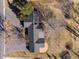 An aerial view showcases the home's layout with a sprawling roofline and circular patio at 22 Wedge Way, Littleton, CO 80123