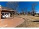 Expansive backyard featuring a charming covered patio, and mature trees at 22 Wedge Way, Littleton, CO 80123