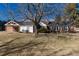 Lovely home with brick accents, a sunroom, and well-maintained landscaping, creating a welcoming curb appeal at 22 Wedge Way, Littleton, CO 80123