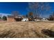 Attractive home with a brick facade, a covered entrance, and a spacious lawn, perfect for outdoor activities at 22 Wedge Way, Littleton, CO 80123