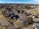 Aerial view captures homes integrated with a well-kept golf course, providing a tranquil living environment at 22 Wedge Way, Littleton, CO 80123