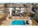 A high-angle aerial shot reveals a luxurious home with pool, patios, manicured landscaping, and neighborhood views at 10057 S Shadow Hill Dr, Lone Tree, CO 80124