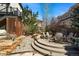 Serene backyard featuring a stone patio with chairs, ideal for outdoor gatherings and enjoying nature at 10057 S Shadow Hill Dr, Lone Tree, CO 80124