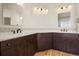 This bathroom features wood floors, dual vanities, and wave pattern backsplash at 10057 S Shadow Hill Dr, Lone Tree, CO 80124