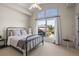 Bedroom with large sunny window, high ceiling and black metal bed frame at 10057 S Shadow Hill Dr, Lone Tree, CO 80124