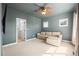 The bedroom is painted blue and features a ceiling fan and tan couch at 10057 S Shadow Hill Dr, Lone Tree, CO 80124