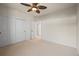 A bright, carpeted bedroom features double closets, neutral walls, and an open doorway at 10057 S Shadow Hill Dr, Lone Tree, CO 80124