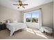 This bedroom has a large window with a view of the neighborhood and a white comforter at 10057 S Shadow Hill Dr, Lone Tree, CO 80124