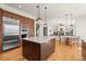 Bright kitchen featuring wood cabinets, stainless steel appliances, and a large center island with a white countertop at 10057 S Shadow Hill Dr, Lone Tree, CO 80124