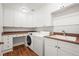 Functional laundry room with white cabinets, a sink, and modern washer and dryer at 10057 S Shadow Hill Dr, Lone Tree, CO 80124