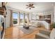 Bright living room featuring a fireplace, large windows, and hardwood floors at 10057 S Shadow Hill Dr, Lone Tree, CO 80124