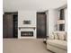 Cozy living room featuring a fireplace, built-in cabinets and shelving, and a comfortable seating arrangement at 10057 S Shadow Hill Dr, Lone Tree, CO 80124