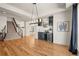 Spacious living room featuring hardwood floors, contemporary light fixture and a stairway at 10057 S Shadow Hill Dr, Lone Tree, CO 80124