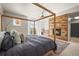 This is a main bedroom with a wooden bed frame and a fireplace with a wooden facade at 10057 S Shadow Hill Dr, Lone Tree, CO 80124