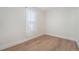 Light-filled bedroom with hardwood flooring and a sheer window covering at 719 W 7Th Ave, Denver, CO 80204