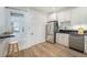 Clean kitchen with a stainless steel refrigerator, modern appliances, and a cozy breakfast bar at 719 W 7Th Ave, Denver, CO 80204