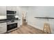 Modern kitchen with stainless steel appliances, granite countertops, and an open layout at 719 W 7Th Ave, Denver, CO 80204