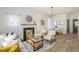 Bright living room featuring a decorative fireplace, chandelier, and modern furniture at 719 W 7Th Ave, Denver, CO 80204