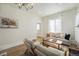 Inviting living room with modern decor, including a comfortable sofa, chairs, and a beautiful painting at 719 W 7Th Ave, Denver, CO 80204