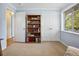 This bedroom features soft blue walls, built-in bookcase, and ample closet space, creating a serene and organized retreat at 746 Birch St, Denver, CO 80220