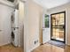 This mudroom with an exterior door features a washer and dryer, adding convenience and functionality to this home at 746 Birch St, Denver, CO 80220