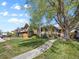 Beautiful home with a spacious front yard, mature trees, and a walkway to the entrance at 746 Birch St, Denver, CO 80220