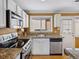 Galley kitchen featuring stainless appliances, granite counters, and white cabinets at 746 Birch St, Denver, CO 80220
