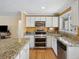 Modern kitchen with white cabinets, stainless steel appliances, and granite countertops at 746 Birch St, Denver, CO 80220