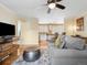 Open-concept living room with hardwood floors, gray sofa, and view into the kitchen at 746 Birch St, Denver, CO 80220