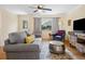 Comfortable living room showcasing a gray sofa, hardwood floors, and a ceiling fan at 746 Birch St, Denver, CO 80220