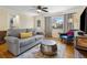 Comfortable living room featuring a gray sofa, patterned rug, and hardwood floors at 746 Birch St, Denver, CO 80220