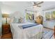 Comfortable bedroom with ceiling fan and natural light from dual windows at 746 Birch St, Denver, CO 80220