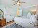 Bedroom with ceiling fan, large bed, hardwood floors, and closet space at 746 Birch St, Denver, CO 80220