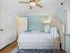 Well-lit bedroom featuring ceiling fan, a large bed, and a doorway at 746 Birch St, Denver, CO 80220