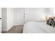 Bright, cozy bedroom with a white door, carpet, and white planked walls provides a clean and simple design at 4718 W 34Th Ave, Denver, CO 80212