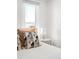 Bedroom with bright window light, modern lamps, a soft, white comforter, and stylish pillows at 4718 W 34Th Ave, Denver, CO 80212