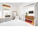 Cozy bedroom with a view into the living room, featuring ample natural light and a functional layout at 4718 W 34Th Ave, Denver, CO 80212