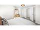 A light-filled bedroom includes a golden mirror, walk in closet, plush pillows, and neutral walls at 4718 W 34Th Ave, Denver, CO 80212