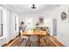 Inviting dining room with hardwood floors, a wooden table, and white curtains, perfect for gatherings at 4718 W 34Th Ave, Denver, CO 80212