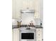 A modern kitchen with an updated range oven, countertops, and cabinetry at 4718 W 34Th Ave, Denver, CO 80212