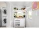 A laundry area with shelving, window, and machines at 4718 W 34Th Ave, Denver, CO 80212