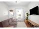 Bright living room with hardwood floors, modern furniture, and a large window, offering a welcoming space at 4718 W 34Th Ave, Denver, CO 80212