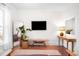 Bright living room featuring hardwood floors, a stylish mirror, and tasteful decor creating a cozy atmosphere at 4718 W 34Th Ave, Denver, CO 80212