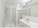 A bathroom featuring a glass shower and a sink with cabinets at 2902 S Meade St, Denver, CO 80236