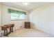 A spare bedroom with neutral carpet and one window at 2902 S Meade St, Denver, CO 80236