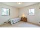 A bright bedroom with two windows, neutral carpet, and a single bed at 2902 S Meade St, Denver, CO 80236