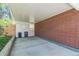 Covered carport area featuring a brick wall and space for vehicle parking and storage at 2902 S Meade St, Denver, CO 80236